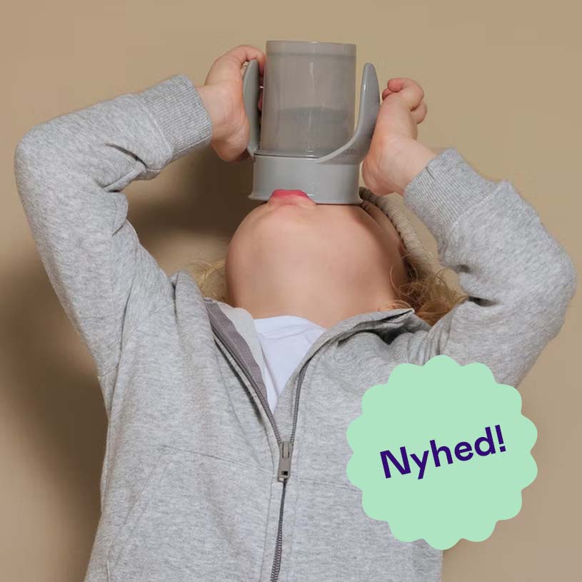 Barn drikker af grå kop, teksten 'Nyhed!' vises.